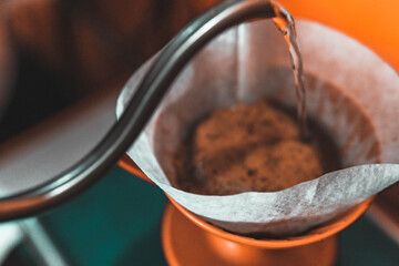 Water pours from the coffee maker into the coffee filter, coffeeshop