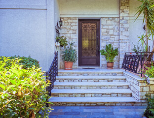 contemporary house entrance stairs to door and flowerpots, Athens Greece