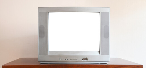 An obsolete vintage silver TV with a blank white screen sits on a vintage table in a 1990s tenement house.