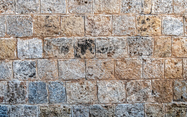 regular cut stone wall closeup, natural textured background