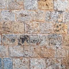 regular cut stone wall closeup, natural textured background