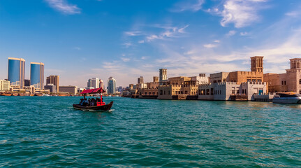 A view up the Dubai Creek towards the restored buildings of old Dubai in the UAE in springtime