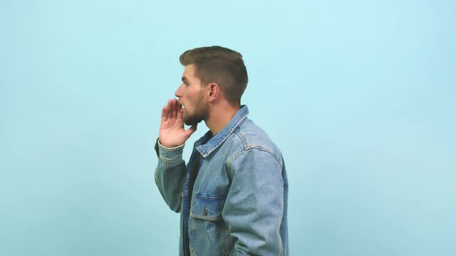 Young caucasian handsome man whispering gossip undertone, trying not to be heard