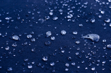 Shiny water droplets on black surface with selective focus