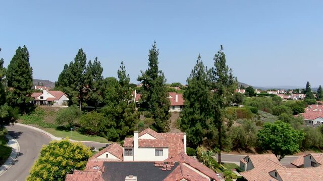Aerial view of middle class neighborhood with residential house community and mountain on the background in Rancho Bernardo, South California, USA.