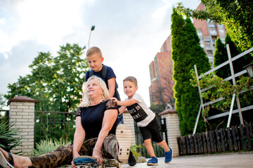 Children having fun with their grandmother.