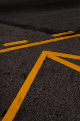 yellow traffic marks painted on asphalt road