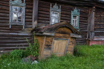 Entrance to the basement of an old wooden village house.