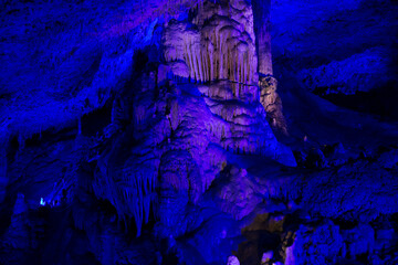 Stalactite illuminated caves in Spain on the island of Mallorca. Multi-colored illumination of caves. Beautiful cave. Stalactites in old cave. 