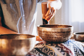 Spa with a masseur and a client who have a relaxing massage with Tibetan music bowls