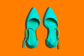 Fashionable women's shoes on an orange background with shadows. Minimal stylish background. Fashion blog.