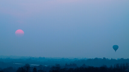 Hot air balloon in sunset countryside