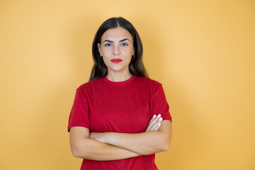 Young beautiful woman over isolated yellow background skeptic and nervous, disapproving expression...