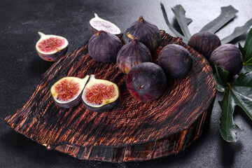 Fresh ripe figs on a dark concrete background. Harvesting figs
