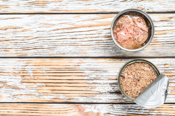 Obraz na płótnie Canvas Canned tuna in a jar. Grey wooden background. Top view. Copy space