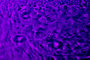 splash of water in lilac light. Abstract wallpaper