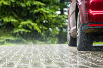 raindrops fall on a paved area, blurred background