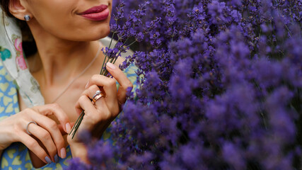 Woman holding a bouquet from lavender flowers in the lavender field