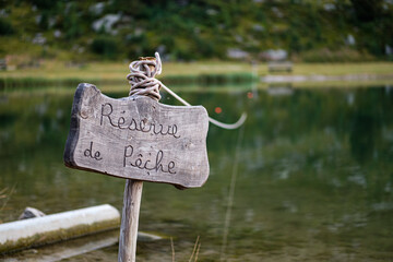 Fishing preserve sign in front of the lake - bokeh