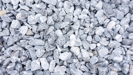 Stone texture of tumbled black marble. Blue-gray background from marble stone for design templates. Marble in landscape design.