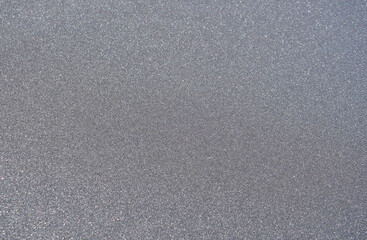 black volcanic sand on the beach uniform background