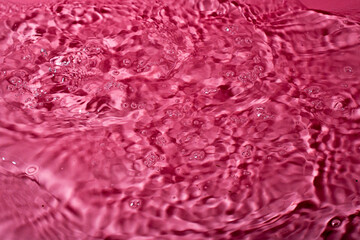 Obraz premium splash of water on a red background. Abstract wallpaper