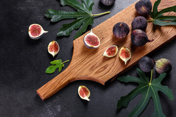 Fresh ripe figs on a dark concrete background. Harvesting figs