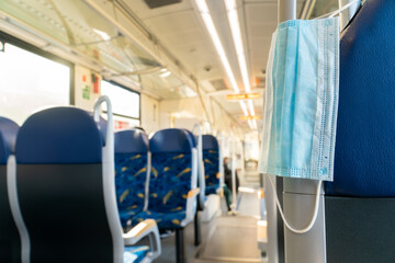 Empty inside train bus subway public transport with window view and blue seats people tourist new normal social distancing safe travel with hygiene face mask protect from covid corona virus