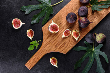 Fresh ripe figs on a dark concrete background. Harvesting figs