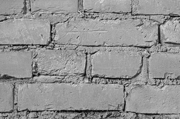 Texture of gray vintage brick wall of a building close up