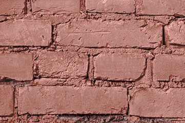 Texture of a red vintage brick wall of a building close up