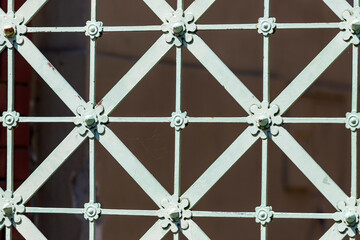 White metal lattice on which are ornaments.