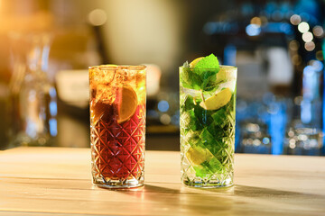 Classic cold cocktails - rum and cola and mojito