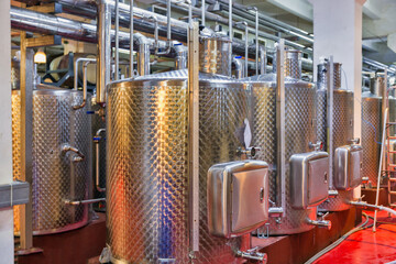 Stainless steel reservoirs for wine at modern winery.
