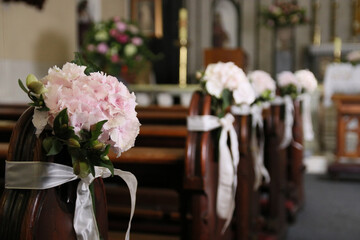 Interior of a catholic church, beautifully decorated with flowers for a wedding ceremony.