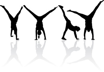 Silhouette of agile young man doing a handstand.
