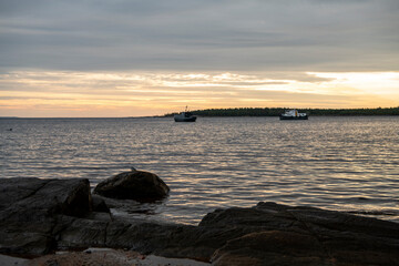 beautiful landscape with old wooden port, stones and sea at sunrise