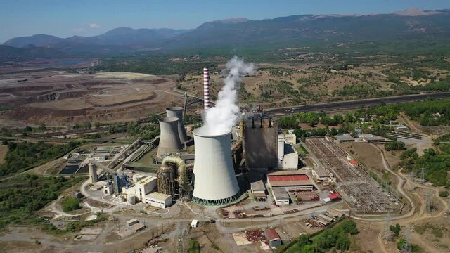 Aerial drone video of Hellenic public electric company industrial power plant complex in town of Megalopolis, Arcadia prefecture, Peloponnese, Greece