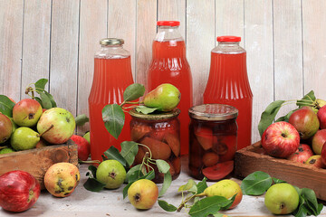 Apple and pear cider, juice, fruit drink and ingredients on a sunny table, home canning. The...