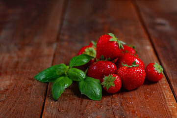 Strawberries on a wooden table - obrazy, fototapety, plakaty