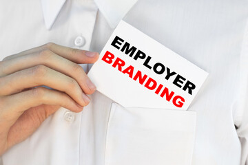 Businessman putting a card with text EMPLOYER BRANDING n the pocket