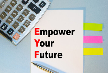 Empower Your Future is written on a notepad next to multicolored stickers, a calculator and a pen on a blue background. Business concept
