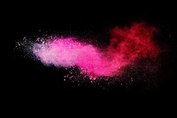 Pink powder explosion on black background. Paint Holi.