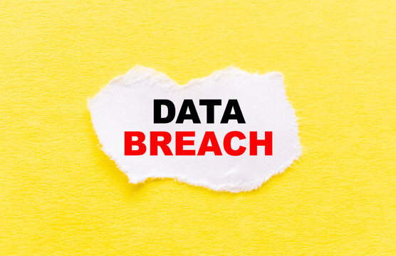the inscription DATA BREACH on a white torn piece of paper on a yellow background