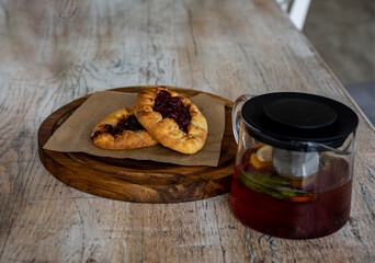 breakfast with tea and pies on a brown table