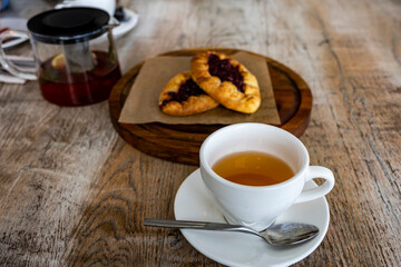 breakfast with tea and pies on a brown table