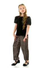 Fototapeta premium Cute little girl in a pantsuit. Isolated on a white background.