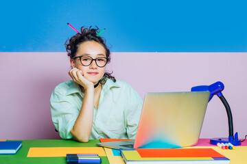 High school girl looking to camera sitting at their desk. Distance elearning course, video...