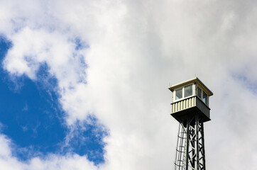 small watchtower against a white / blue sky