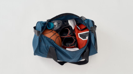 Top view of a sports bag with professional uniform, ball, sneakers and bottle of water isolated on...